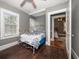 Bedroom with natural light, hardwood floors, and neutral walls that open up into another bedroom at 310 N Lincoln Ave, Clearwater, FL 33755