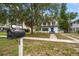 Charming two-story home with a well-manicured lawn, featuring a mailbox in the foreground at 310 N Lincoln Ave, Clearwater, FL 33755