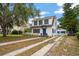 Charming two-story home showcasing the front exterior, driveway, and well-maintained landscaping at 310 N Lincoln Ave, Clearwater, FL 33755