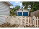 Two car garage behind a white picket fence at 310 N Lincoln Ave, Clearwater, FL 33755