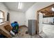 Unfinished garage space with an open door, file cabinet, and boxes against a white wall at 310 N Lincoln Ave, Clearwater, FL 33755
