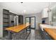 Spacious kitchen with stainless steel refrigerator, butcher block countertops, and decorative patterned flooring at 310 N Lincoln Ave, Clearwater, FL 33755