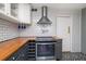 Updated kitchen features stainless steel oven, butcher block counters, and wine storage at 310 N Lincoln Ave, Clearwater, FL 33755