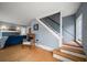 Cozy living room with hardwood floors, a fireplace, and open staircase design at 310 N Lincoln Ave, Clearwater, FL 33755