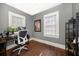 Office space featuring hardwood floors, two windows, and a computer desk at 310 N Lincoln Ave, Clearwater, FL 33755