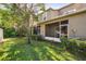 A spacious backyard with a screened in porch for relaxing and enjoying nature with privacy fence at 31215 Flannery Ct, Wesley Chapel, FL 33543