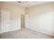 Cozy bedroom featuring carpeted floors, a ceiling fan, and neutral walls, providing a versatile and comfortable living space at 31215 Flannery Ct, Wesley Chapel, FL 33543