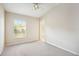Comfortable bedroom with vaulted ceiling, ceiling fan, and natural light from a large window at 31215 Flannery Ct, Wesley Chapel, FL 33543