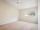 Neutral bedroom with a ceiling fan, carpet, and window letting in natural light, creating a relaxing and comfortable space at 31215 Flannery Ct, Wesley Chapel, FL 33543
