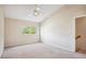 Bright bedroom features a vaulted ceiling, large window with green tree views and a ceiling fan at 31215 Flannery Ct, Wesley Chapel, FL 33543