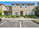 Inviting townhouse exterior features a well-maintained lawn and convenient parking at 31215 Flannery Ct, Wesley Chapel, FL 33543