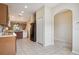 Open kitchen features tile flooring and black appliances at 31215 Flannery Ct, Wesley Chapel, FL 33543