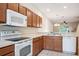 Bright kitchen featuring matching appliances and wood cabinets at 31215 Flannery Ct, Wesley Chapel, FL 33543