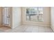 Bright room with tile flooring, a large window, and an entry door at 31215 Flannery Ct, Wesley Chapel, FL 33543