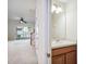 Cozy powder room with a single sink vanity, mirror, and view to the living room at 31215 Flannery Ct, Wesley Chapel, FL 33543