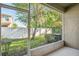 A screened in porch with a view of the backyard for relaxing and enjoying nature at 31215 Flannery Ct, Wesley Chapel, FL 33543