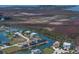 Aerial view of waterfront homes along canals surrounded by marshland and wetlands under a sunny sky at 3397 Bluefish Dr, Hernando Beach, FL 34607