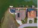 Aerial view of the property showcasing the home, screened pool, dock, and waterfront location at 3397 Bluefish Dr, Hernando Beach, FL 34607