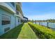 Manicured lawn with a retaining wall overlooking private dock and boat lift at 3397 Bluefish Dr, Hernando Beach, FL 34607