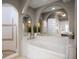 Bathroom with a large soaking tub, tile floors, archways, and a tiled walk-in shower at 3397 Bluefish Dr, Hernando Beach, FL 34607