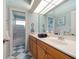 Well-lit bathroom with double sink vanity, a large mirror, and a separate shower room at 3397 Bluefish Dr, Hernando Beach, FL 34607