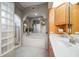 Elegant bathroom featuring a soaking tub, glass block details, and tiled shower at 3397 Bluefish Dr, Hernando Beach, FL 34607