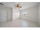 Bright bedroom with tile floors, a ceiling fan, and natural light from the window at 3397 Bluefish Dr, Hernando Beach, FL 34607