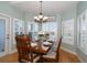 Dining area featuring a wooden table with seating for six near large, shuttered windows at 3397 Bluefish Dr, Hernando Beach, FL 34607