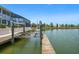 Home's private dock and boat lift offers convenient access to the water, screened in back patio and lush landscaping at 3397 Bluefish Dr, Hernando Beach, FL 34607
