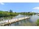 A floating dock over a small body of water, reflecting the blue sky and surrounded by lush green vegetation at 3397 Bluefish Dr, Hernando Beach, FL 34607