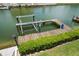 Private dock with boat lift and blue yard art offers convenient water access and waterfront enjoyment at 3397 Bluefish Dr, Hernando Beach, FL 34607