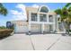 Charming two-story coastal home with a three-car garage and well-manicured landscaping at 3397 Bluefish Dr, Hernando Beach, FL 34607