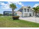 Charming coastal home with a three-car garage, second-floor balcony, and lush landscaping at 3397 Bluefish Dr, Hernando Beach, FL 34607
