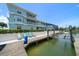 Stunning waterfront property featuring a private dock with boat lift, outdoor seating, and lush landscaping at 3397 Bluefish Dr, Hernando Beach, FL 34607