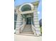 Beautiful front entrance featuring a grand staircase and an elegant blue front door at 3397 Bluefish Dr, Hernando Beach, FL 34607