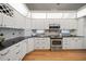 Spacious kitchen with stainless steel appliances, granite countertops and white cabinets at 3397 Bluefish Dr, Hernando Beach, FL 34607
