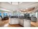 Open concept kitchen with an island, white cabinetry, and stainless steel appliances at 3397 Bluefish Dr, Hernando Beach, FL 34607