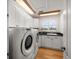 Well-lit laundry room with washer, dryer, cabinets, and sink at 3397 Bluefish Dr, Hernando Beach, FL 34607