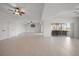 Spacious living room featuring tile floors, ceiling fans, and access to an outdoor porch at 3397 Bluefish Dr, Hernando Beach, FL 34607