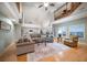 Open-concept living room features a loft, hardwood floors, and a comfortable sectional sofa at 3397 Bluefish Dr, Hernando Beach, FL 34607