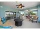 Spacious screened-in patio features comfortable seating, a ceiling fan, and views of the water at 3397 Bluefish Dr, Hernando Beach, FL 34607