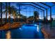 Captivating indoor pool area features a serene waterfall and lush tropical landscaping at 3397 Bluefish Dr, Hernando Beach, FL 34607
