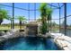 Up close view of screened in pool with waterfall feature at 3397 Bluefish Dr, Hernando Beach, FL 34607