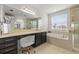 Bright bathroom with a vanity, bathtub, and separate glass shower, offering a spa-like retreat at 3541 Great Banyan Way, Wesley Chapel, FL 33543