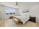 Light and airy bedroom with a large window, white bedding, and decorative accents at 3541 Great Banyan Way, Wesley Chapel, FL 33543