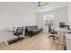 Versatile room with two desks, a sofa, and a ceiling fan, creating a flexible space for work or relaxation at 3541 Great Banyan Way, Wesley Chapel, FL 33543