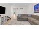 Upstairs bonus room showcasing a large sectional sofa, TV, and mini basketball hoops at 3541 Great Banyan Way, Wesley Chapel, FL 33543