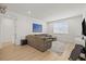Bonus room features hardwood floors, sectional sofa, entertainment center, and natural lighting at 3541 Great Banyan Way, Wesley Chapel, FL 33543