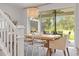 Bright dining room with modern chandelier, large table, and sliding glass doors to the outdoor patio at 3541 Great Banyan Way, Wesley Chapel, FL 33543
