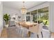Elegant dining room with a stylish chandelier, sliding glass doors to the lanai, and modern furnishings at 3541 Great Banyan Way, Wesley Chapel, FL 33543
